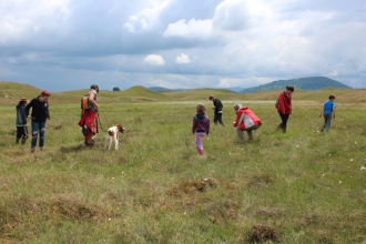 image of people exploring the wetland at eycott hill with dog on lead