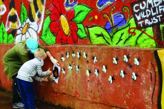 Image of people decorating Florence Mine as part of Get Cumbria Buzzing event in Egremont