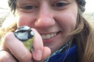 Kate Cartmell-Done holding blue tit whilst ringing