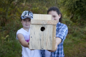 Image of children holding a bird box credit Paul Harris/2020Vision