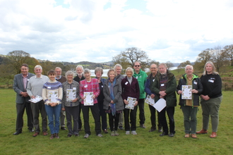 Image of Cumbria Wildlife Trust volunteers receiving Badger's Paw Awards