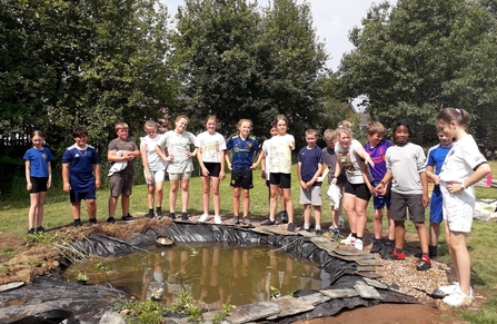 Image of Year 6 pupils at St Cuthbert's Catholic Primary School Botcherby with new school pond