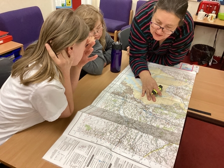 teacher and pupils looking at map