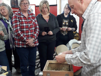 Image of George Pilkington dressing bumblebee nesting box