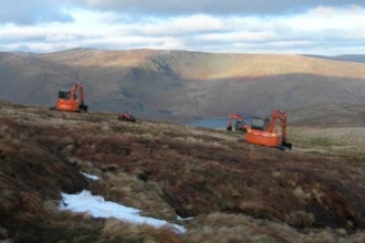Diggers repair damaged peat in the Lake District fells