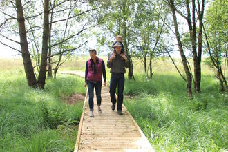 image of young family walking on path - Foulshaw moss