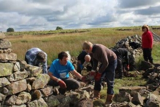 Eycott Hill volunteers repairing a drystone wall