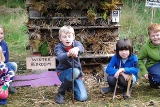 Children building a bug hotel