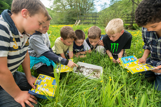 Image of children looking for insects © Ross Hoddinott-2020VISION