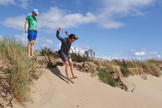 Image of children in sand dunes © Cumbria Wildlife Trust