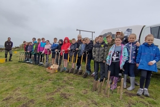 Image of schoolchildren with spades St Bees Village Primary School credit Cumbria Wildlife Trust