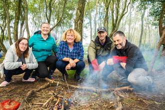 people around a campfire on a wild wellbeing day