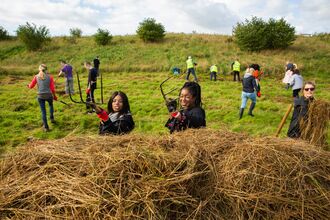 a group of people haymaking on a wild wellbeing day