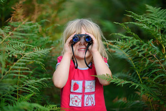 Child with binoculars bird watching