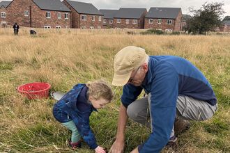 A family helping to plug plant at Cold Springs nature reserve