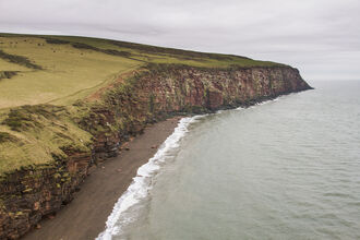 Photo shows a cliff overlooking the sea