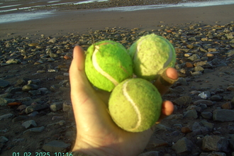 Three discarded tennis balls