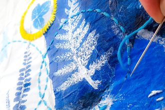 A detailed shot of a piece of art from Create Botanical Art with print collage and stitch. A creative workshop. 