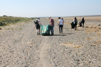 Group of beach clean volunteers enjoying themselves