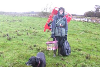 Volunteer transporting rubbish to the collection point