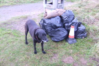 Black bags full of waste awaiting transport to the recycling facility