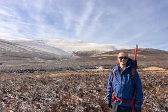 Isaac Johnston with Skiddaw in background, snow on the top