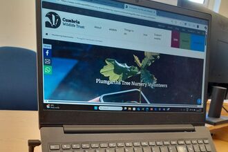 An open laptop showing Cumbria Wildlife Trust's webpage