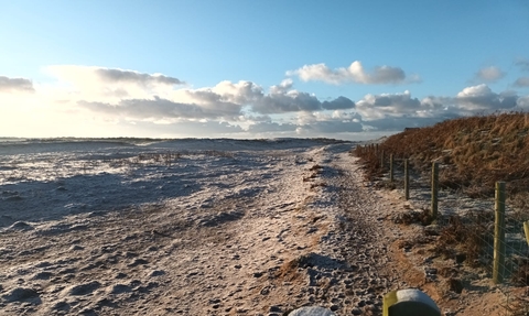 A view of a path along the edge of the beach and dunes at South Walney during frosty weather