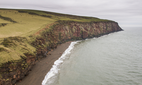 Photo shows a cliff overlooking the sea