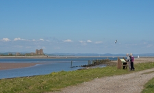 couple reading interpretation panel at south walney nature reserve with piel castle in background copyright john morrison