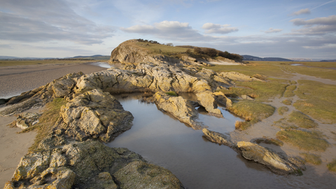 image of Limestone outcrop on edge of saltmarsh and mudflats at Humphrey Head onMorecambe Bay in Cumbria