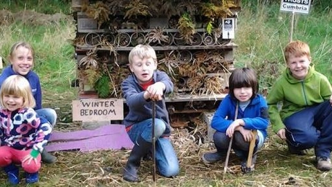 Children building a bug hotel