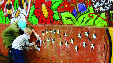 Image of people decorating Florence Mine as part of Get Cumbria Buzzing event in Egremont