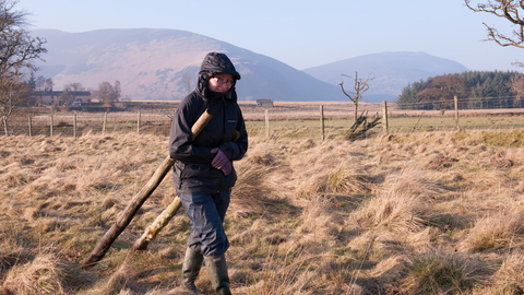 Volunteer moving fencing material at Eycott Hill © Ben Wolstencroft