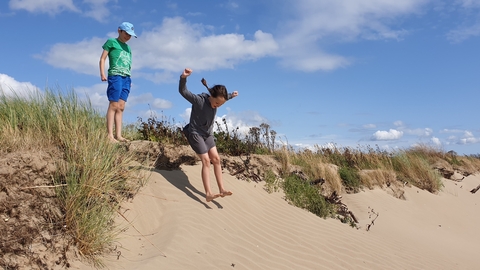 Image of children in sand dunes © Cumbria Wildlife Trust
