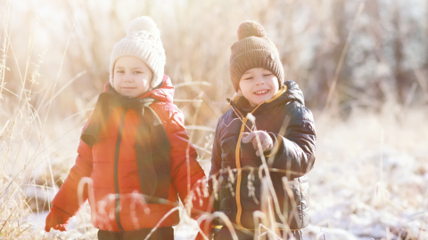 Two children walking through a frosty landscape