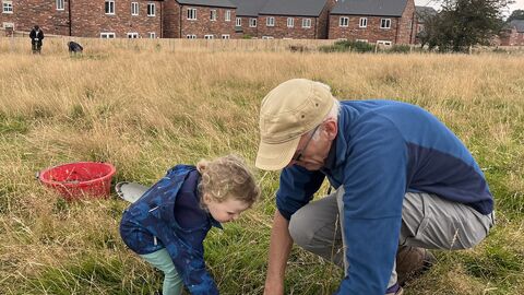 A family helping to plug plant at Cold Springs nature reserve