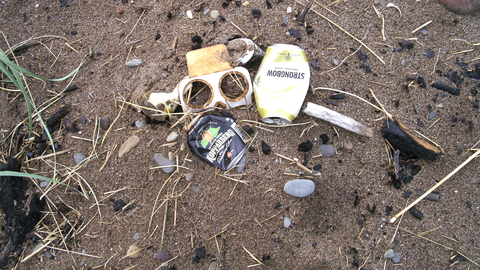 Debris from a campfire on the beach