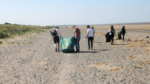 Group of beach clean volunteers enjoying themselves