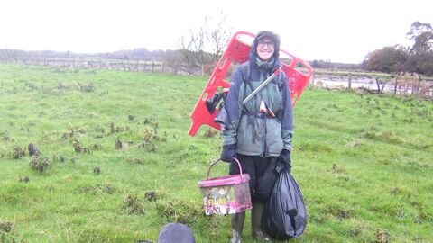 Volunteer transporting rubbish to the collection point