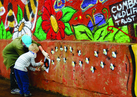 Image of people decorating Florence Mine as part of Get Cumbria Buzzing event in Egremont