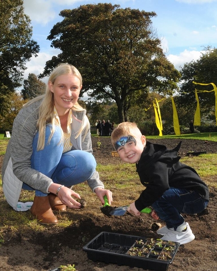 Mum and child planting wildflowers