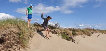 Image of children in sand dunes © Cumbria Wildlife Trust