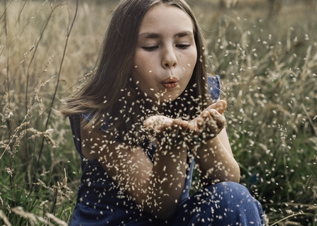 Image of young girl blowing seeds credit Tom and Evie Photography