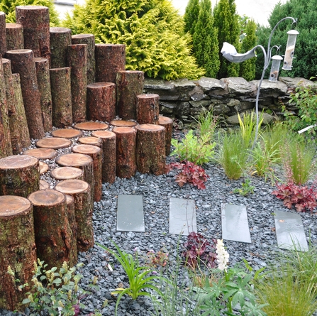 Garden log sofa made from logs standing on end