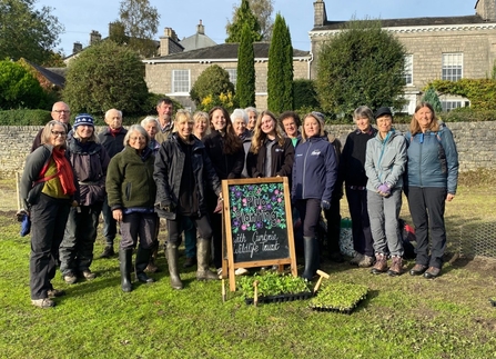 Group shot of volunteers with planting equipment