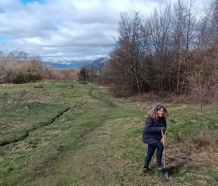 Volunteer Natalie Thorp planting shrubs