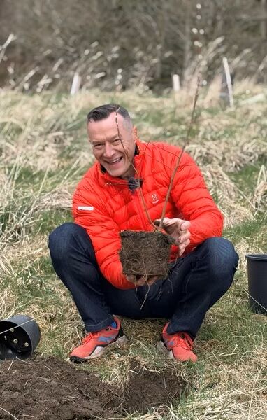 Neil Cooper Director at Crossbank Dental Care planting tree at Staveley Woods
