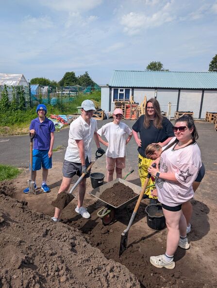 Kings Trust group of people moving soil