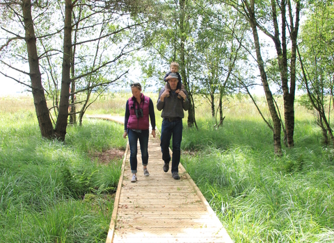 image of young family walking on path - Foulshaw moss